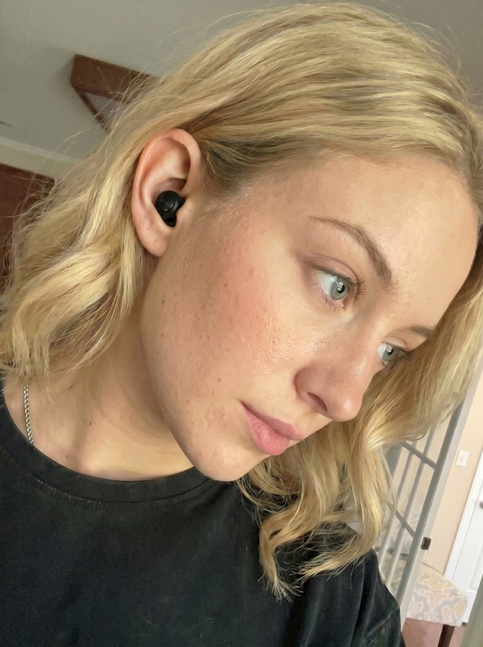 Sarah M. wearing a Quiet earplug at home