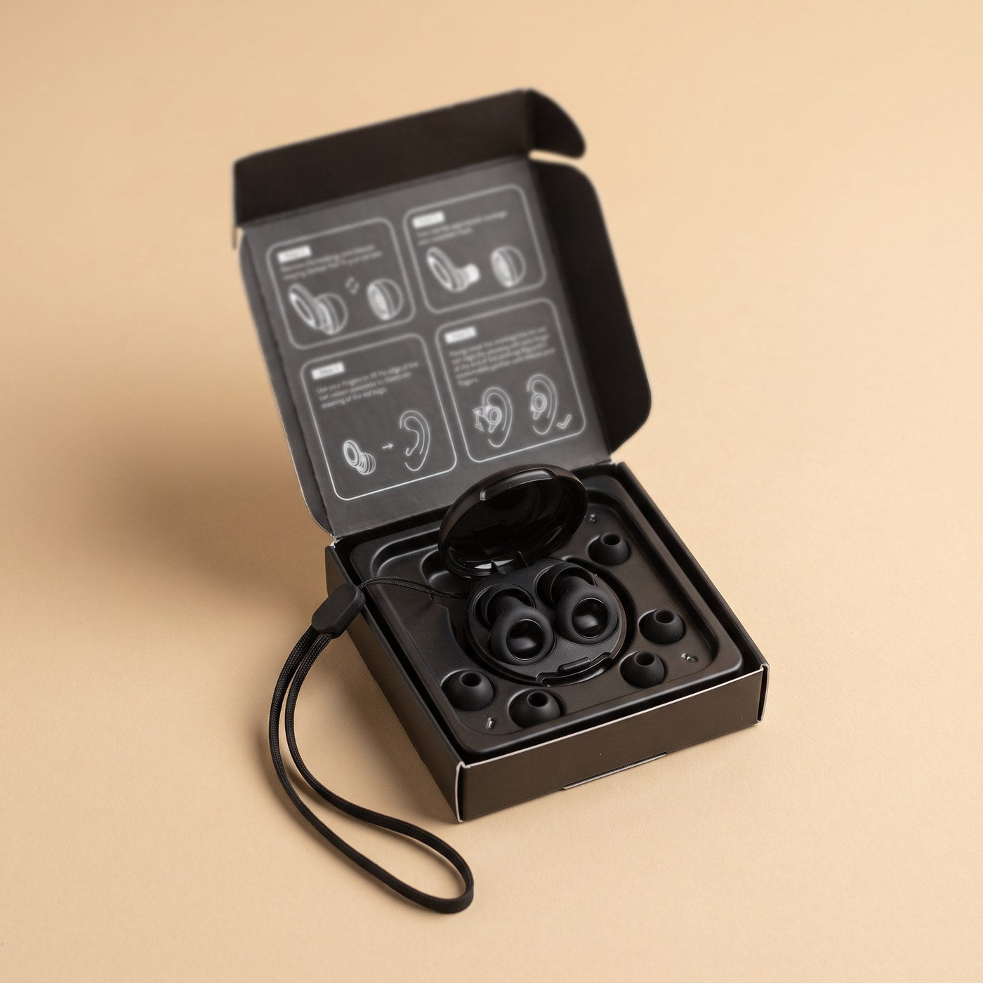 The opened Quiet box as it arrives - case earplugs four tip sizes and lanyard in the tray