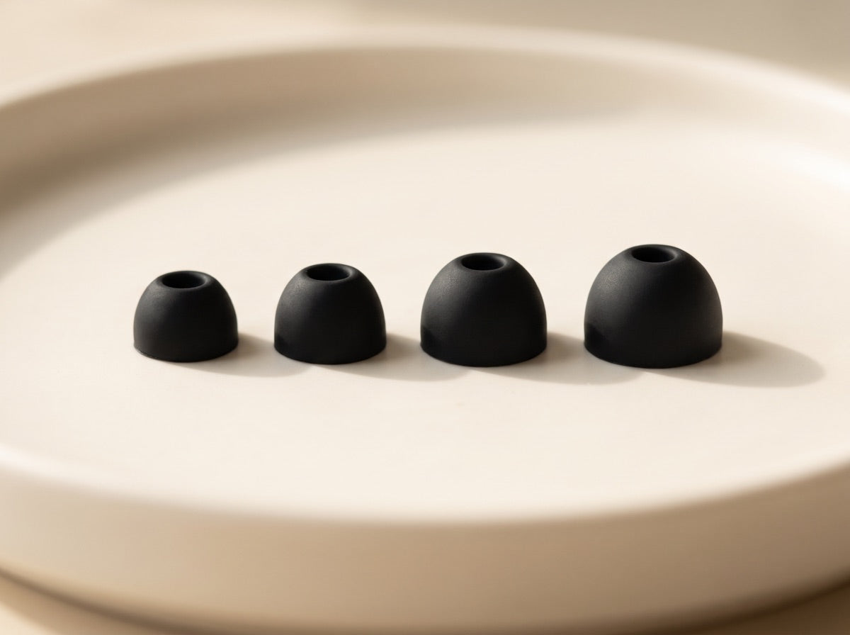 The four included silicone ear tips lined up in a row from smallest to largest
