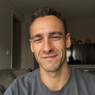 Marcus B. at home in a grey t-shirt