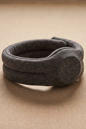A padded fabric sleep headphone headband lying folded
